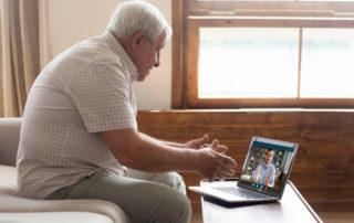 connect with seniors senior man on video chat on laptop