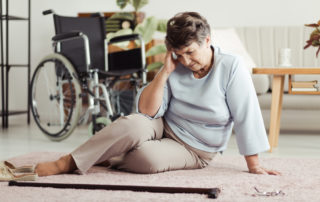 prevent seniors from falling senior woman on the floor holding head