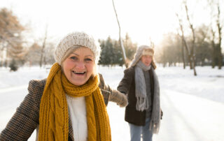 Happy senior couple outside in snow