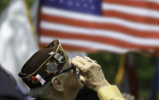 A senior veteran salutes the flag