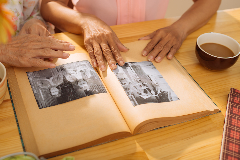 Two seniors working on a scrapbook together