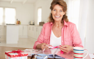 A senior woman working on her scrapbook while at memory care in Macomb, MI