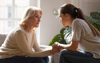 A concerned daughter talking to her senior mother about moving to the dementia assisted living facilities near me