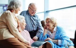 A group of senior friends talking and hanging out at the memory care in Macomb, MI
