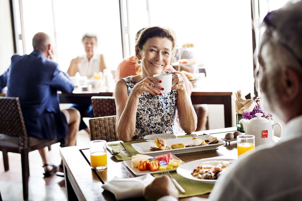 Senior woman enjoying breakfast at her senior living apartments macomb